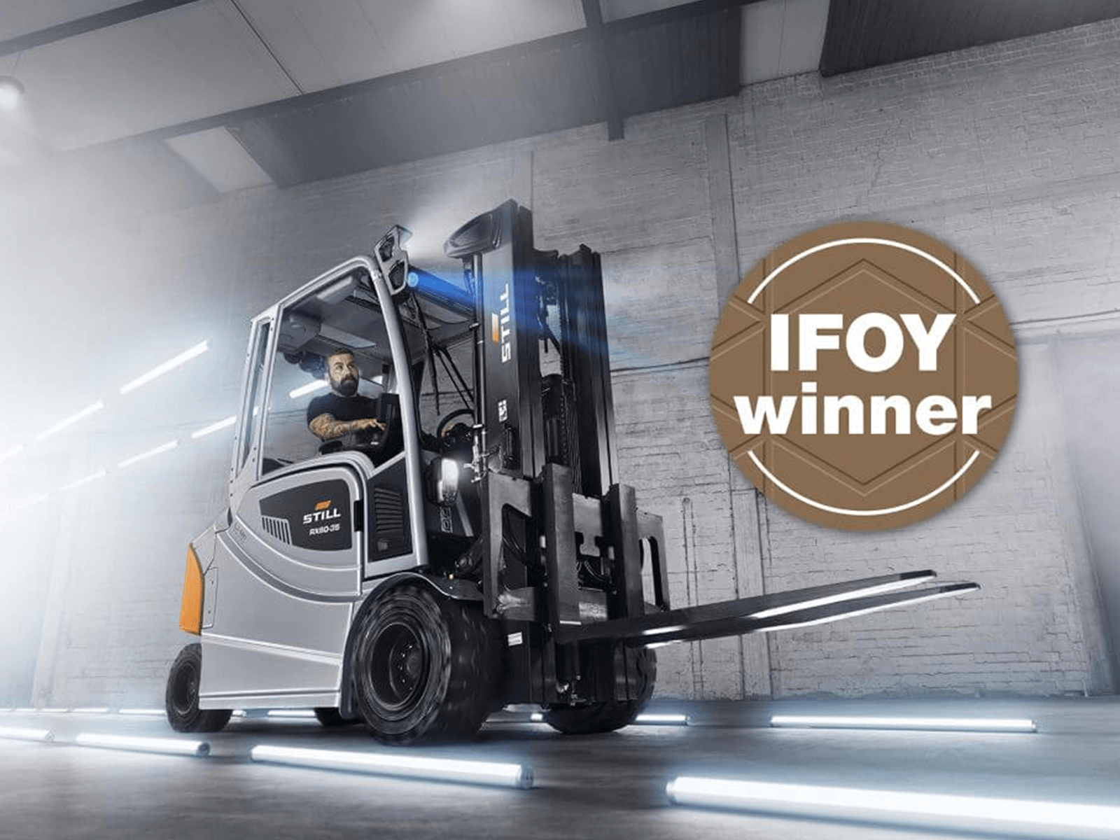A modern forklift featuring the IFOY winner badge, showcasing its advanced design and functionality in a well-lit setting.