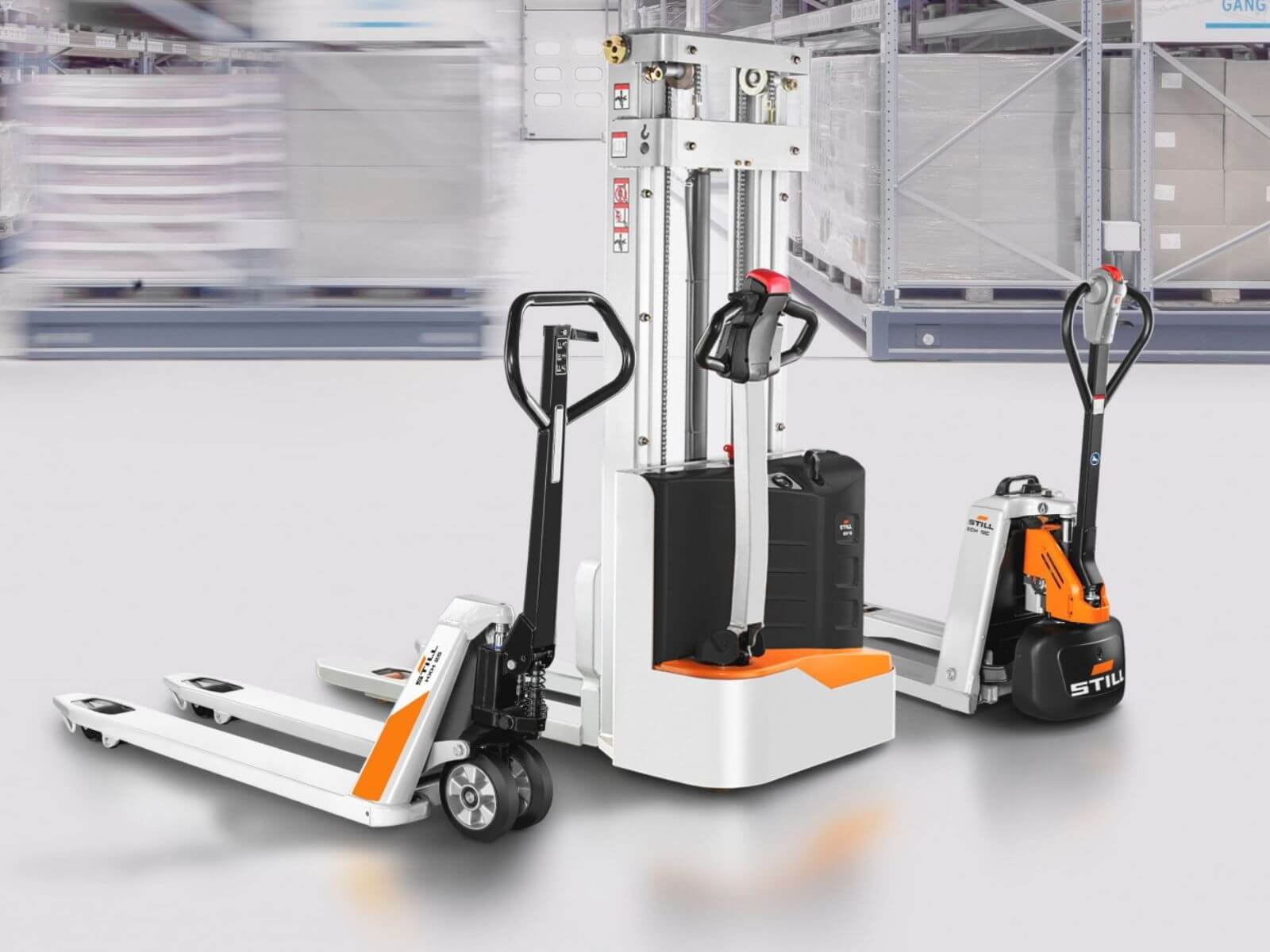Two electric pallet stackers in a warehouse, showcasing advanced material handling equipment.