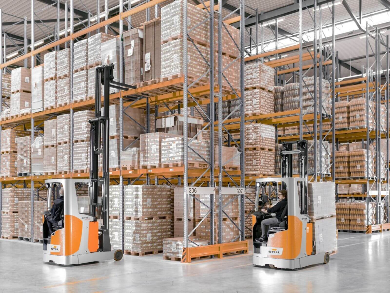 Efficient Warehouse Operation with Forklifts Two forklifts operating in a large warehouse filled with pallets on shelves