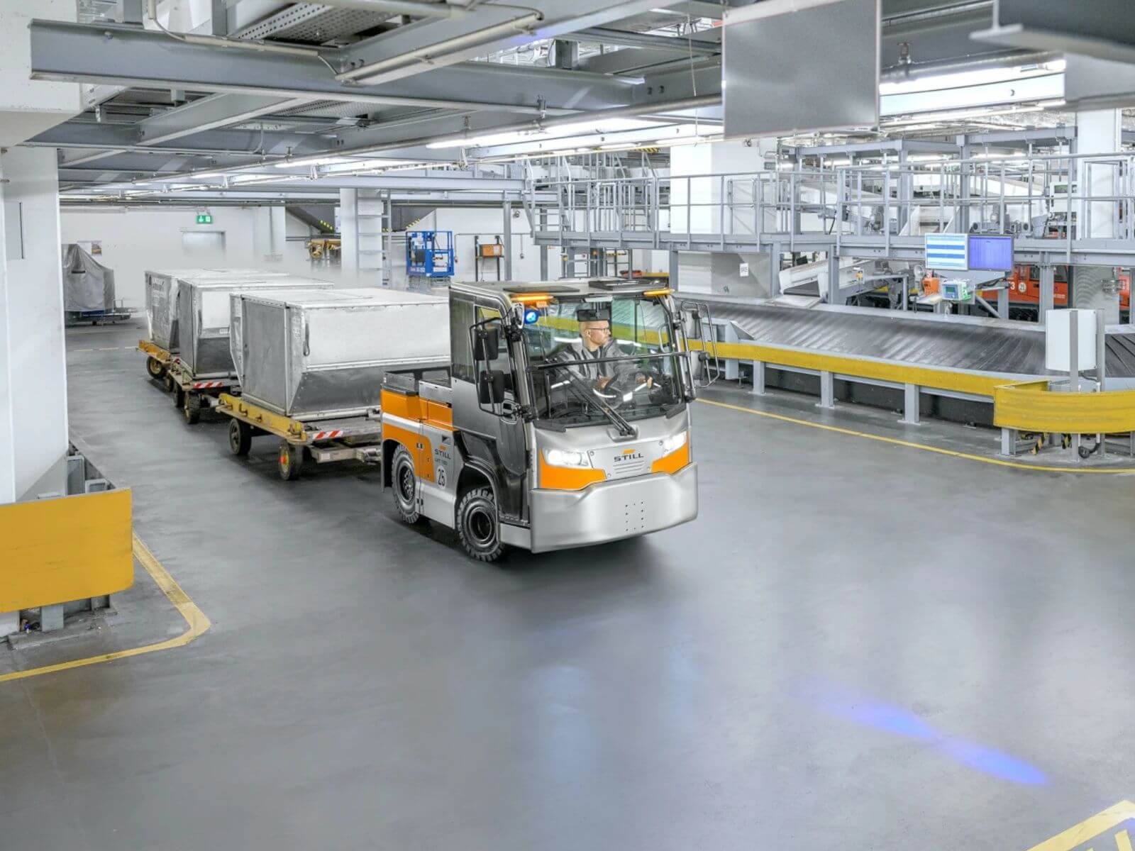 Modern Warehouse with Forklift and Cargo Transport A modern warehouse interior featuring a forklift transporting cargo on a trailer, with a structured setting and organized storage areas.